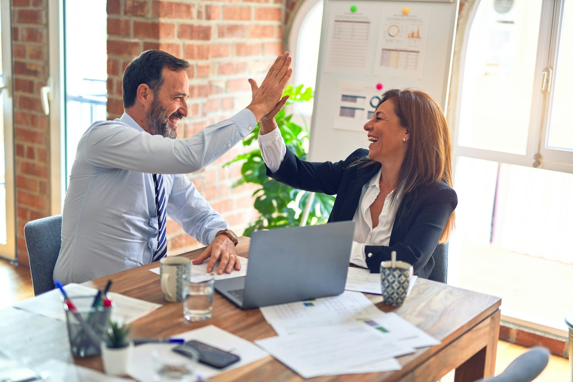 Financial advisors celebrating a successful client outcome